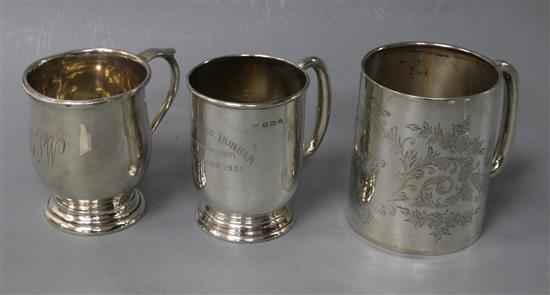 A George V engraved silver christening mug and two other silver christening mugs.